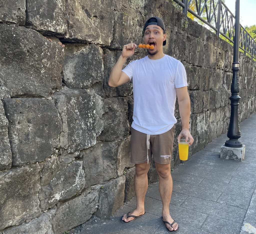 Tour guide in Intramuros showing the wall of Intramuros